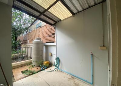 Covered backyard area with water tank