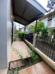 Outdoor path with covered roof leading to the main door