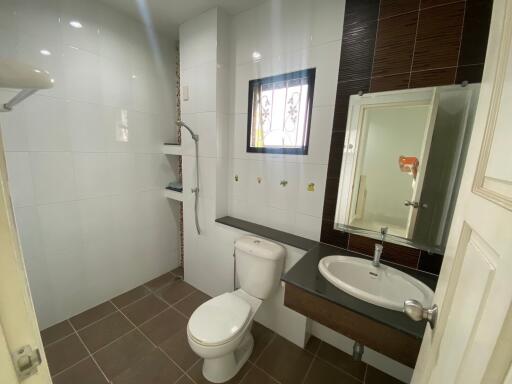 Modern bathroom with white tiles and dark accents