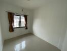 Empty bedroom with window and curtains