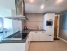 Modern kitchen with integrated appliances and breakfast bar