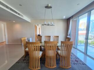 Modern dining room with wooden chairs and glass table