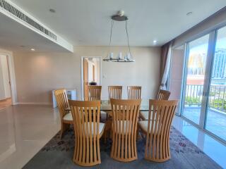 Modern dining room with wooden chairs and a large window