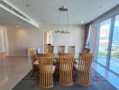 Modern dining room with wooden chairs and a large window