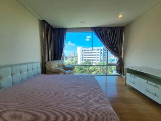 Large bedroom with a panoramic window and city view