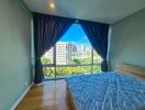 Bedroom with large window and city view