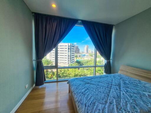 Bedroom with large window and city view