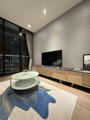 Modern living room with TV and glass coffee table