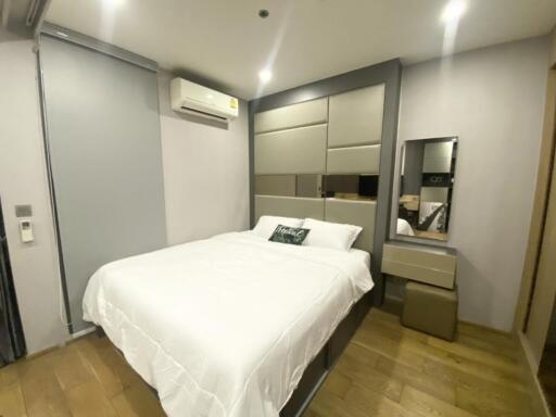 Modern bedroom with bed, air conditioner, and dresser