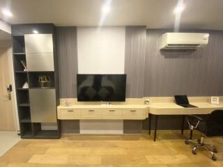 modern living area with TV and workspace