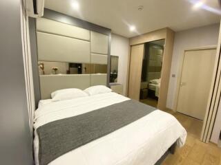 Modern bedroom with large bed and mirrored wardrobe