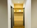 Well-lit modern hallway with wooden floor and built-in shelving