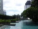 Luxurious outdoor pool area with greenery and city view