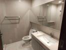 Modern bathroom with large mirror and white fixtures