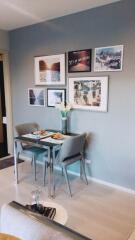 Small dining area with table and chairs, wall art, and modern decor