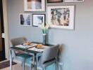 Small dining area with table and chairs, wall art, and modern decor