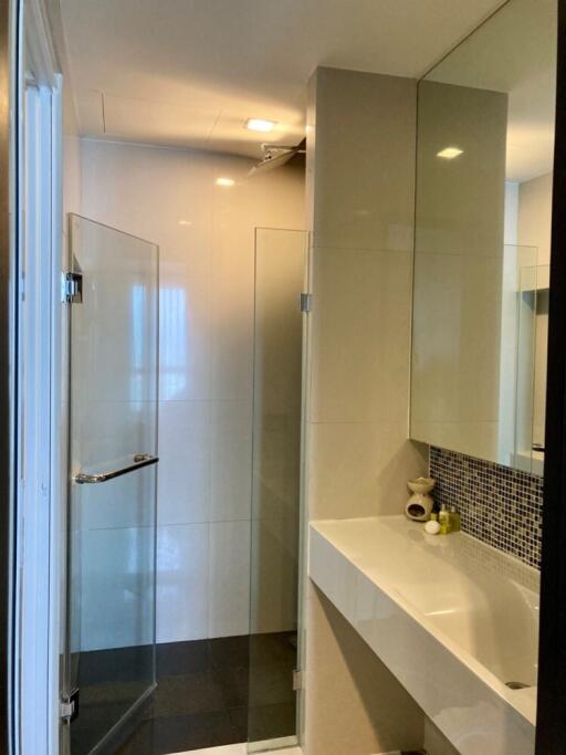 Modern bathroom with glass shower and large mirror