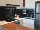 Modern kitchen with built-in appliances and wooden countertop