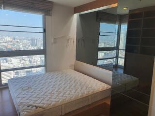 Modern bedroom with large windows and city view