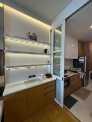 Modern kitchen with wooden cabinetry and sliding glass doors
