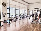 Spacious fitness gym with modern equipment and wooden flooring