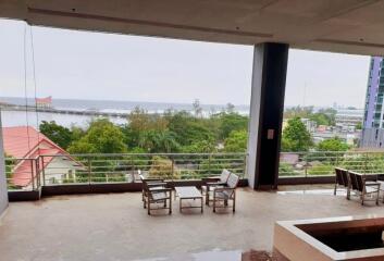 Spacious balcony with seating area overlooking a scenic view