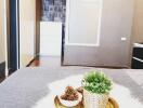 Modern bedroom with potted plants on a bed tray