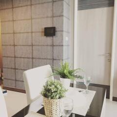 Modern dining area with decorative plants and contemporary furnishings