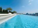 Photo of an outdoor pool area with city view