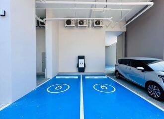 Indoor electric vehicle charging station in a parking area