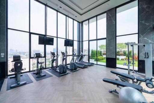 modern gym with large windows and exercise equipment