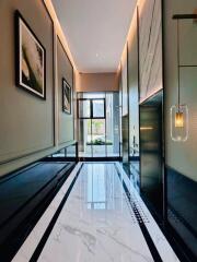 Modern hallway with marble flooring and glass door