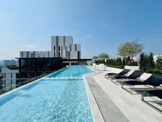 rooftop swimming pool with lounge chairs and city view