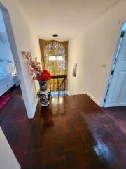 Upstairs hallway with wooden floor and decorative elements