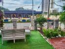 Outdoor garden with seating and view of the street