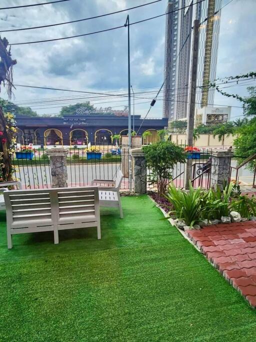 Outdoor garden with seating and view of the street