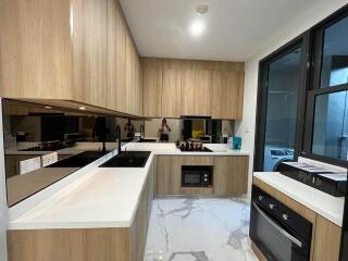 Modern kitchen with wooden cabinets and marble floor