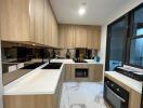 Modern kitchen with wooden cabinets and marble floor