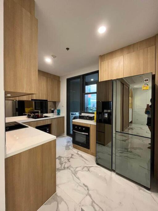 Modern kitchen with wooden cabinetry and marble floors