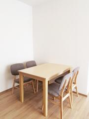 Dining area with wooden table and four chairs