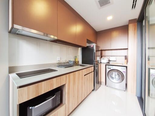 Modern kitchen with stainless steel appliances and wooden cabinets