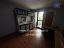 Small kitchen with wooden flooring and a balcony door