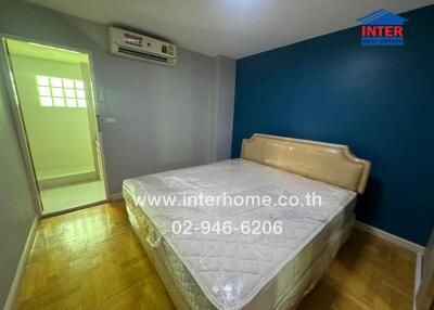 Bedroom with a bed, attached air conditioning, and an adjoining bathroom