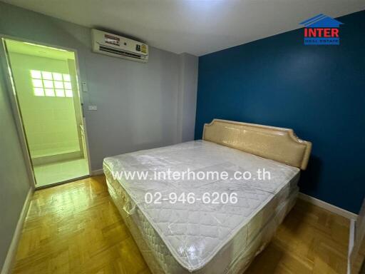 Bedroom with a bed, attached air conditioning, and an adjoining bathroom