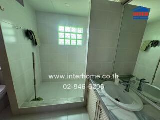 A modern bathroom with a shower area and a sink