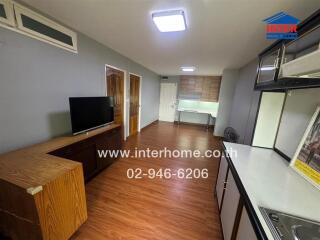 Living area with television and wooden floor