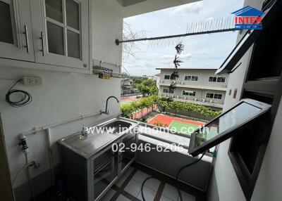 Balcony with a sink and storage cabinets