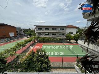 View of tennis courts and surrounding buildings