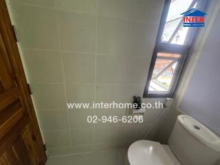 Bathroom with tiled walls and window