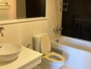 Modern bathroom with white fixtures and a bathtub